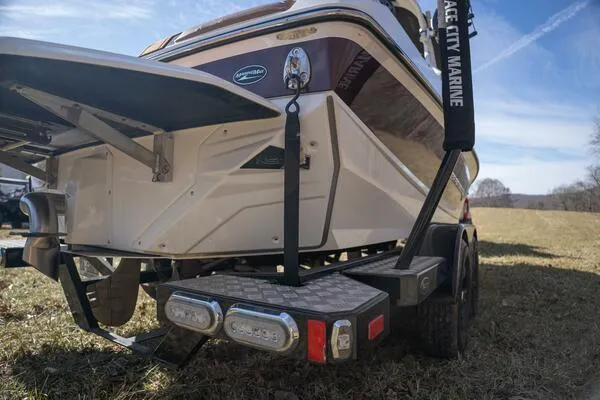 Slide: The Image of 2017 Correct Craft Super Air Nautique GS boat on trailer, rear view in grassy field. - 27