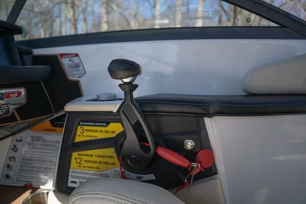 Slide: The Image of 2017 Correct Craft Super Air Nautique GS interior with throttle control and capacity labels. - 28