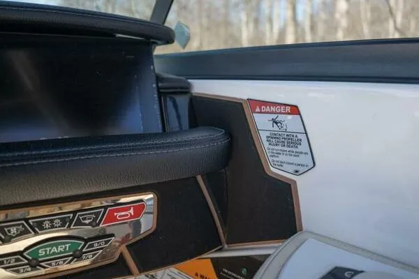 Slide: The Image of Dashboard of 2017 Correct Craft Super Air Nautique GS with warning label and control buttons. - 35