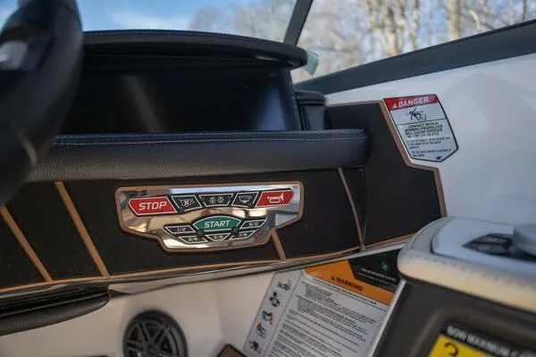 Slide: The Image of Control panel of 2017 Correct Craft Super Air Nautique GS boat with start and stop buttons. - 38