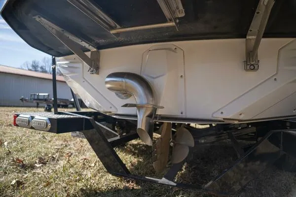 Slide: The Image of 2017 Correct Craft Super Air Nautique GS boat propeller and trailer on grass. - 4