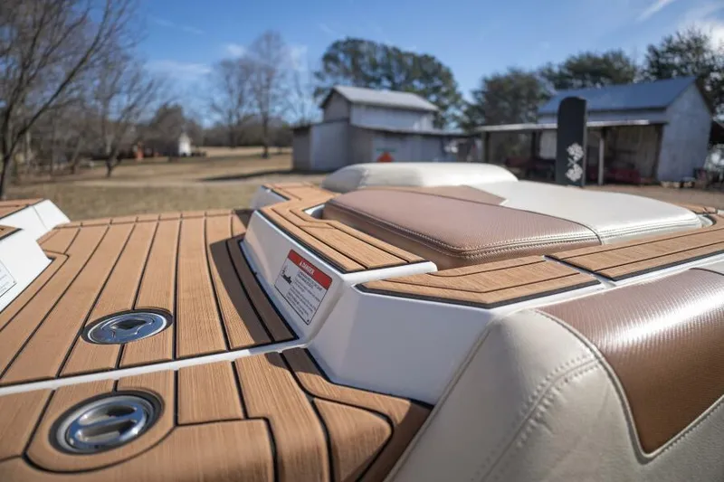 Slide: The Image of 2017 Correct Craft Super Air Nautique GS boat with teak deck, rural background. - 40
