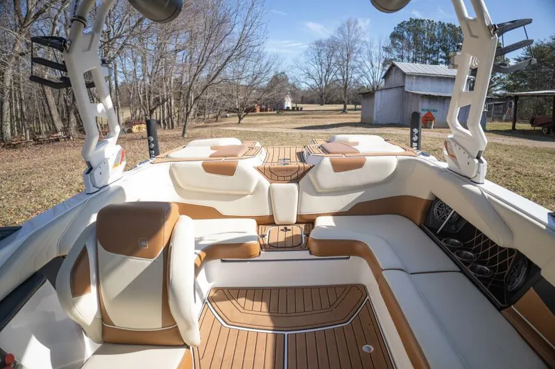Slide: The Image of 2017 Correct Craft Super Air Nautique GS interior with tan and white seating, outdoor setting. - 43