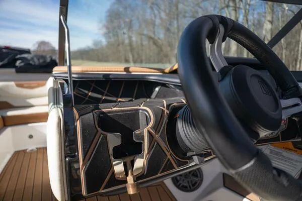 Slide: The Image of Steering wheel of 2017 Correct Craft Super Air Nautique GS boat, featuring modern design. - 5