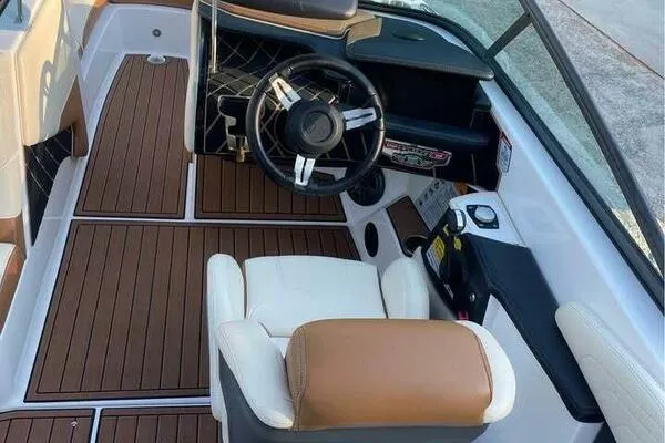 Slide: The Image of 2017 Correct Craft Super Air Nautique GS interior with wood flooring and modern steering wheel. - 6
