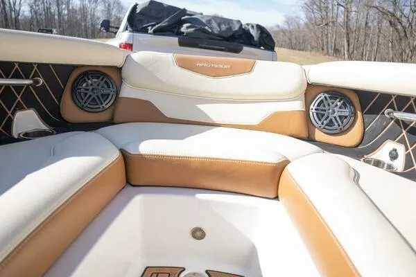 Slide: The Image of 2017 Correct Craft Super Air Nautique GS interior with tan and white seating, featuring built-in speakers. - 8