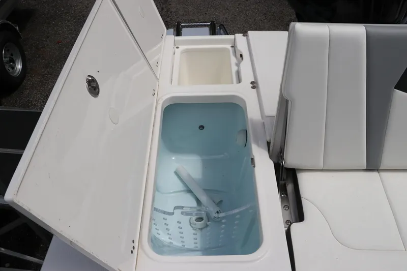 Slide: The Image of 2025 Robalo 226 Cayman boat interior with open storage compartments and seating. - 11