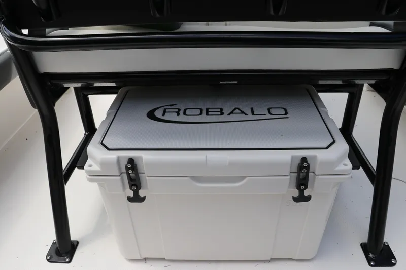 Slide: The Image of 2025 Robalo 226 Cayman boat cooler under seat, featuring secure latches. - 14