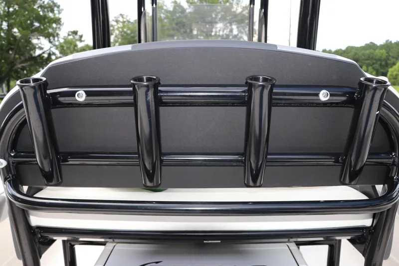 Slide: The Image of 2025 Robalo 226 Cayman boat rod holders, black metal, outdoor setting. - 15