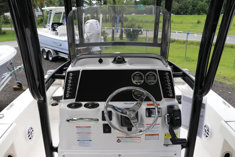 Slide: The Image of 2025 Robalo 226 Cayman boat dashboard with steering wheel and control panel. - 20
