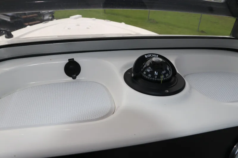 Slide: The Image of 2025 Robalo 226 Cayman boat dashboard with Ritchie compass. - 23
