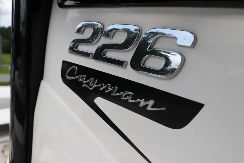 Slide: The Image of 2025 Robalo 226 Cayman boat emblem in chrome and black. - 26