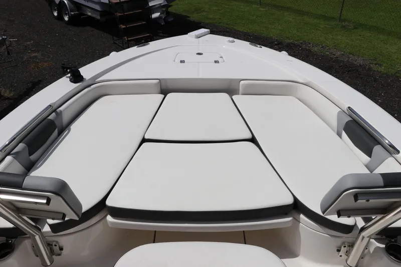 Slide: The Image of 2025 Robalo 226 Cayman boat with spacious cushioned seating area. - 30