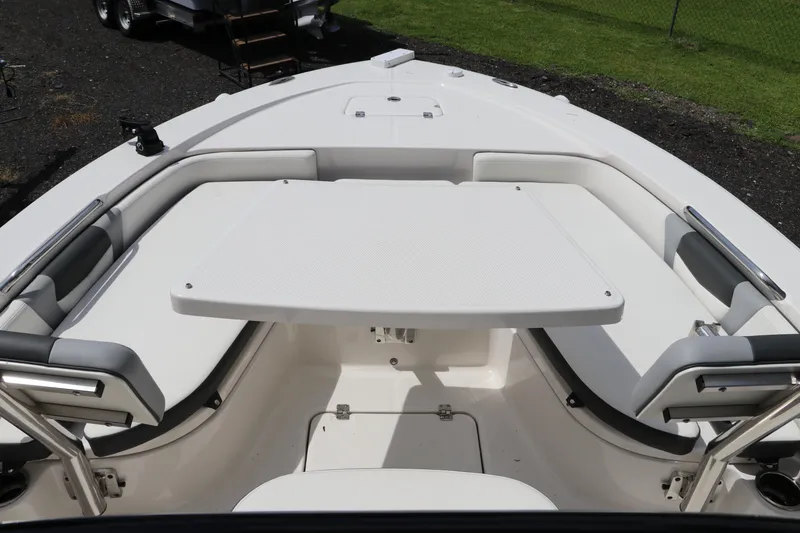 Slide: The Image of 2025 Robalo 226 Cayman boat interior with seating and table setup. - 31