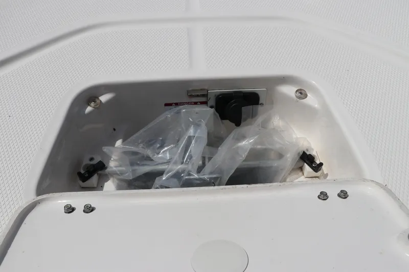 Slide: The Image of Storage compartment on 2025 Robalo 226 Cayman boat, featuring secure latches and protective covering. - 37