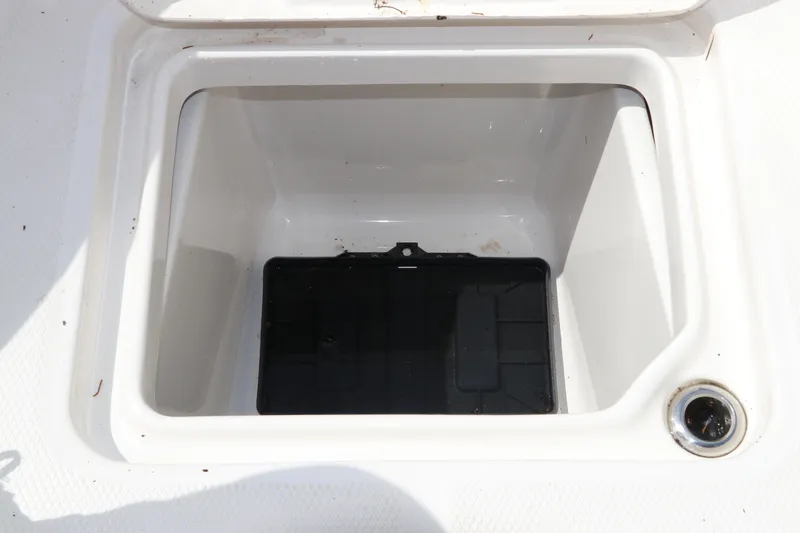 Slide: The Image of 2025 Robalo 226 Cayman storage compartment with black insert. - 38