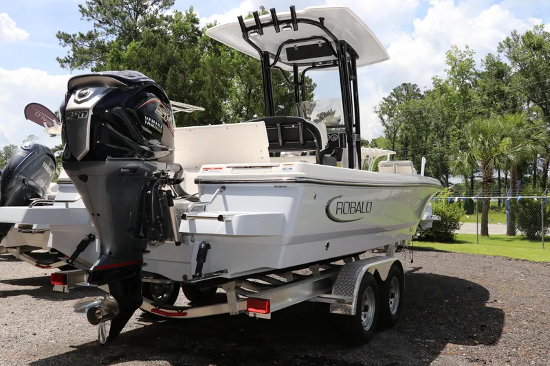 Slide: The Image of 2025 Robalo 226 Cayman boat on trailer, featuring Yamaha outboard motor, parked outdoors. - 4