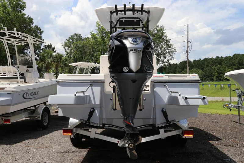 Slide: The Image of 2025 Robalo 226 Cayman boat with powerful outboard motor, parked outdoors. - 5