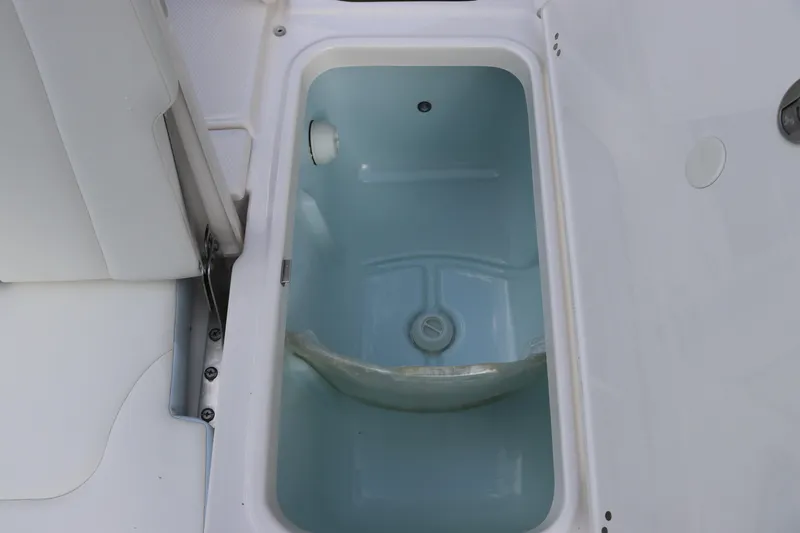Slide: The Image of Livewell compartment on 2025 Robalo 226 Cayman boat, open and empty. - 14