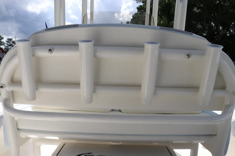 Slide: The Image of 2025 Robalo 226 Cayman boat rod holders, white finish, under a cloudy sky. - 17