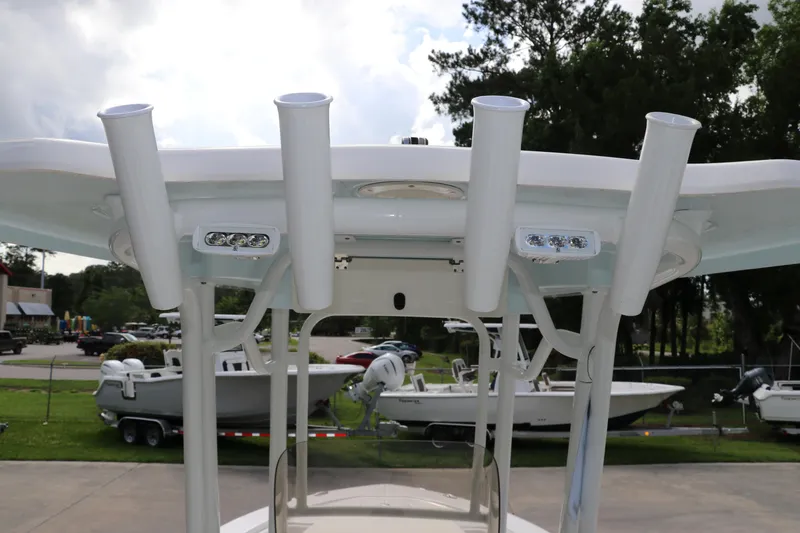 Slide: The Image of 2025 Robalo 226 Cayman boat with rod holders and LED lights on T-top. - 18