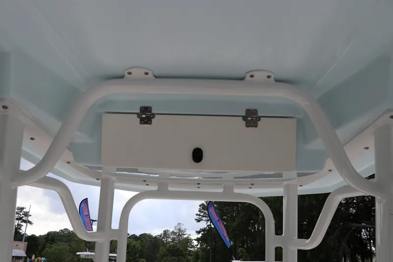 Slide: The Image of 2025 Robalo 226 Cayman boat interior view with storage compartment and sturdy framework. - 19