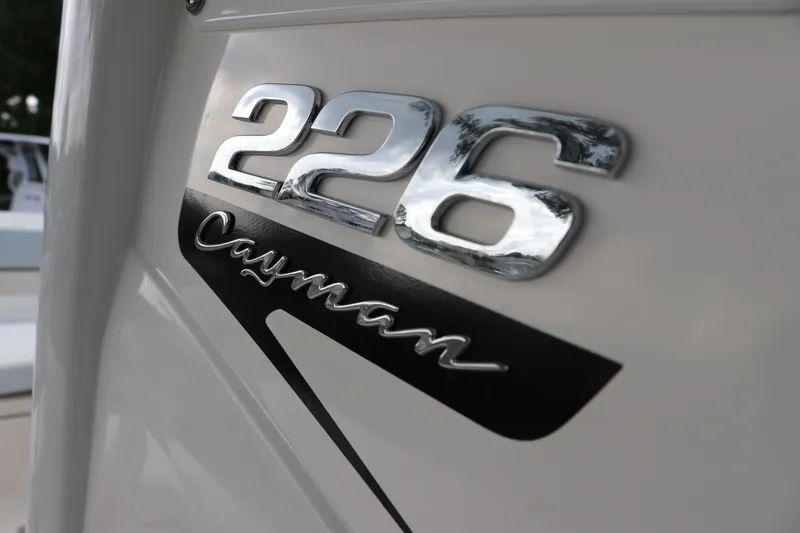 Slide: The Image of 2025 Robalo 226 Cayman boat emblem in chrome and black. - 27