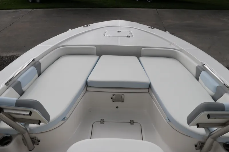 Slide: The Image of 2025 Robalo 226 Cayman boat interior with cushioned seating and storage compartments. - 31