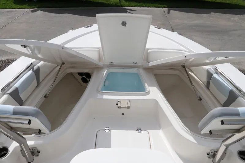 Slide: The Image of 2025 Robalo 226 Cayman boat interior with open storage compartments and seating. - 33