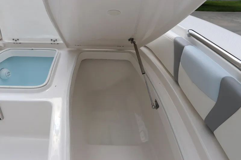 Slide: The Image of 2025 Robalo 226 Cayman boat storage compartment and seating detail. - 36