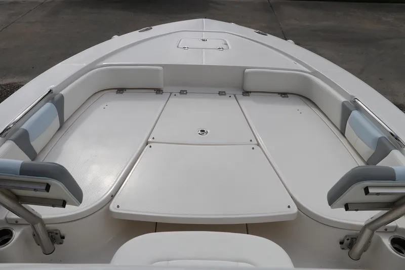 Slide: The Image of 2025 Robalo 226 Cayman boat interior with cushioned seating and storage compartments. - 37