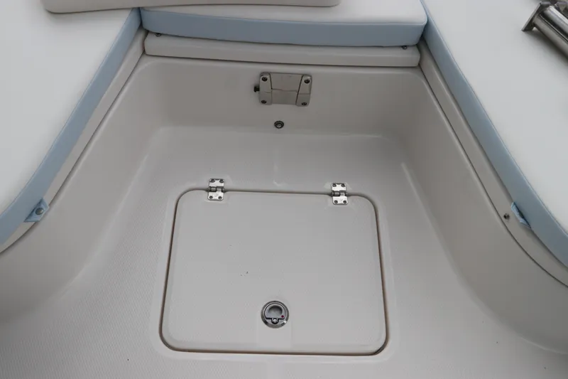 Slide: The Image of 2025 Robalo 226 Cayman boat storage compartment with light blue trim. - 39