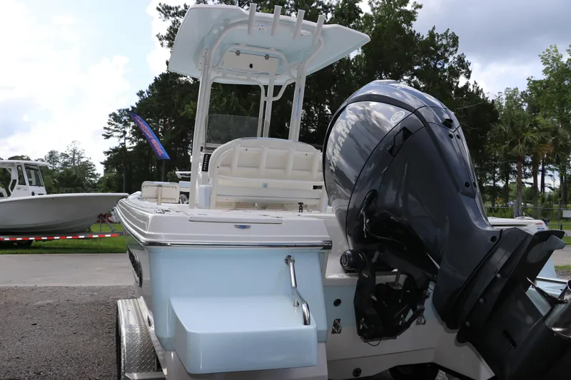 Slide: The Image of 2025 Robalo 226 Cayman boat with Yamaha outboard motor, parked outdoors. - 4