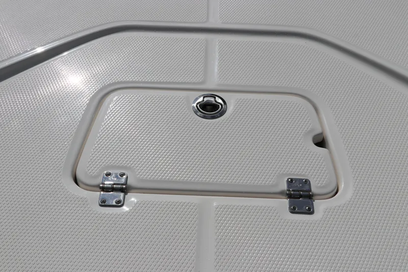 Slide: The Image of 2025 Robalo 226 Cayman boat deck with textured surface and hatch. - 41