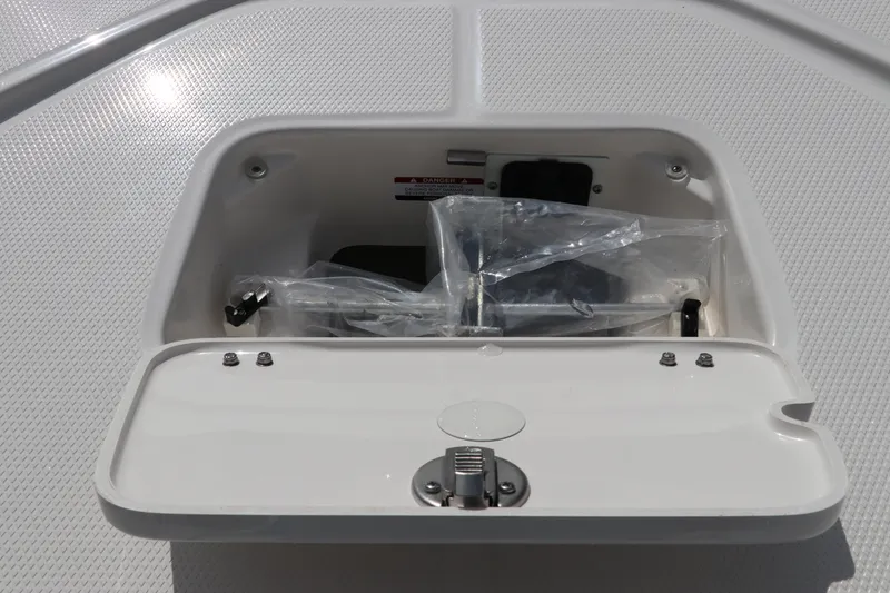 Slide: The Image of Storage compartment on 2025 Robalo 226 Cayman boat, featuring secure latch and protective cover. - 42