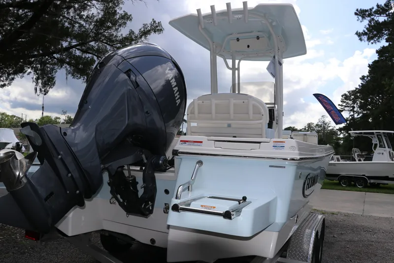 Slide: The Image of 2025 Robalo 226 Cayman boat with Yamaha engine, parked outdoors. - 6