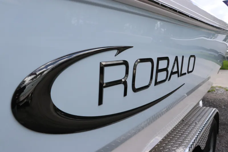 Slide: The Image of 2025 Robalo 226 Cayman boat logo on sleek white hull. - 7