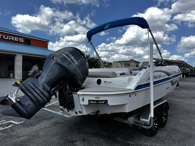 Slide: The Image of 2020 Starcraft MDX 211 OB boat with Yamaha outboard motor, parked outdoors under cloudy sky. - 1