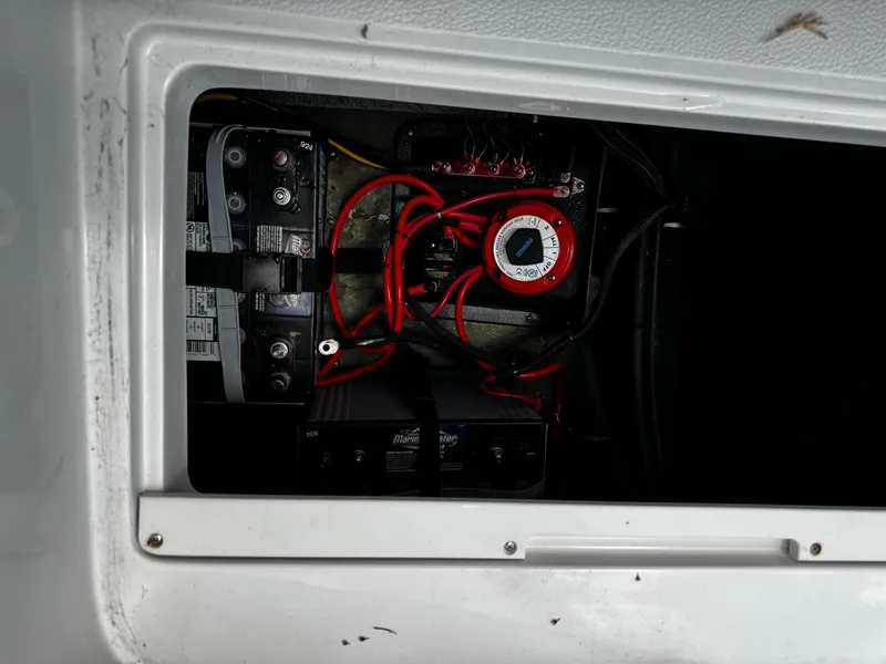 Slide: The Image of Battery compartment of 2020 Starcraft MDX 211 OB with wiring and connections. - 12