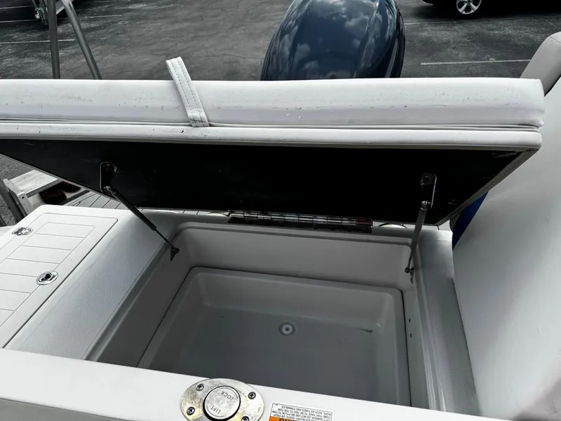 Slide: The Image of 2020 Starcraft MDX 211 OB boat storage compartment with open lid, showcasing interior space. - 16