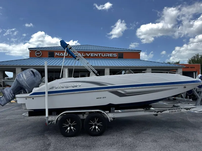 Slide: The Image of 2020 Starcraft MDX 211 OB boat on trailer, parked outside Nautical Ventures store. - 3