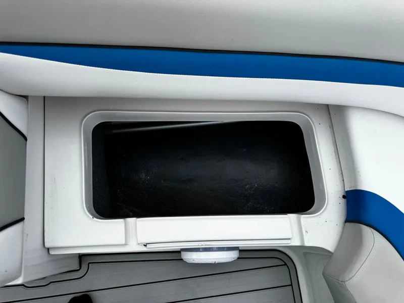 Slide: The Image of Storage compartment on a 2020 Starcraft MDX 211 OB boat, featuring blue and white interior. - 8