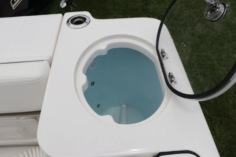 Slide: The Image of 2024 Robalo R230 Center Console livewell with open lid, showcasing interior design. - 10