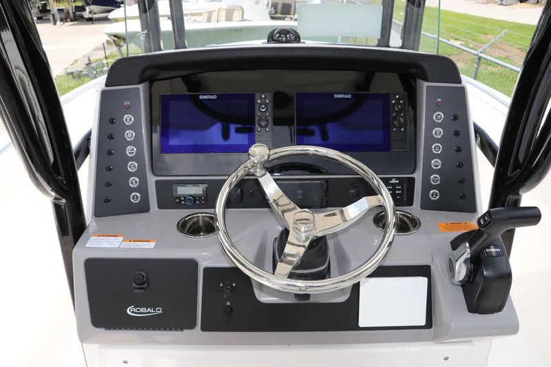 Slide: The Image of 2024 Robalo R230 Center Console dashboard with steering wheel and Simrad displays. - 16