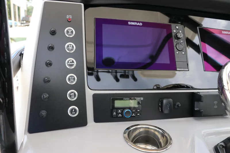 Slide: The Image of 2024 Robalo R230 Center Console dashboard with Simrad displays and control panel. - 17