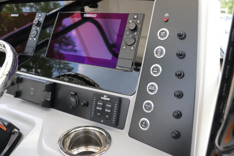 Slide: The Image of 2024 Robalo R230 Center Console dashboard with Simrad displays and control panel. - 19
