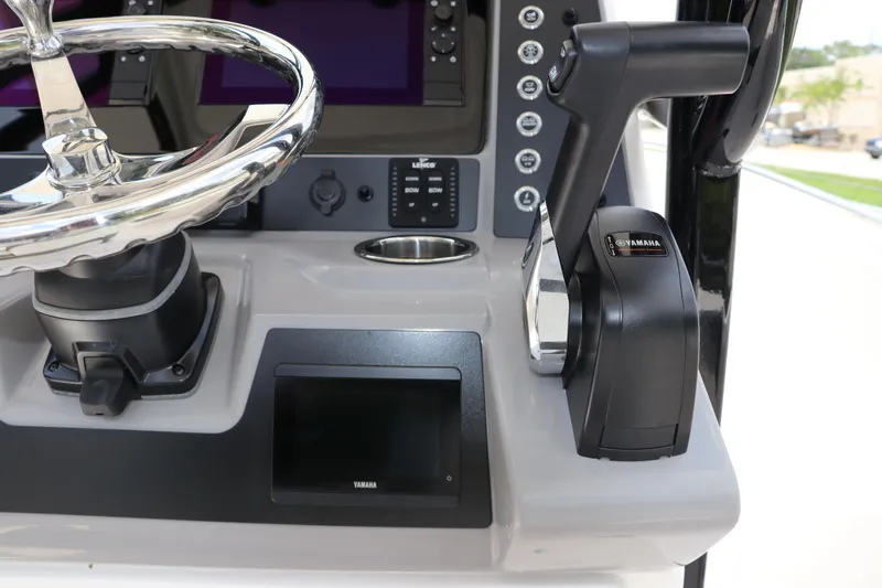 Slide: The Image of 2024 Robalo R230 Center Console dashboard with Yamaha controls and steering wheel. - 20