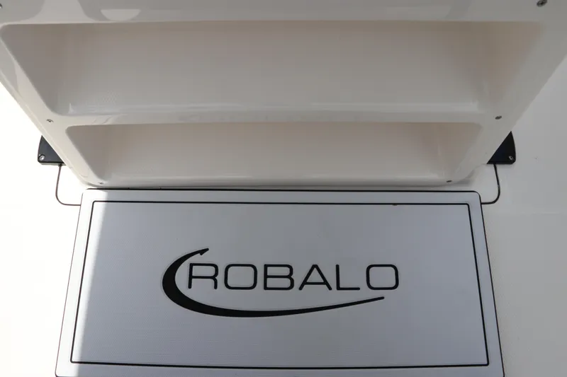 Slide: The Image of 2024 Robalo R230 Center Console storage compartment with logo. - 21