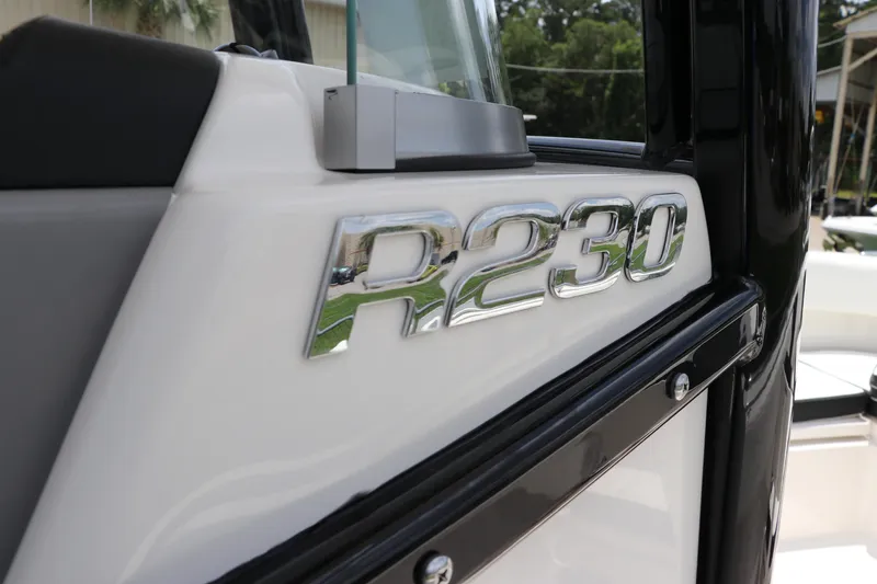 Slide: The Image of 2024 Robalo R230 Center Console boat emblem close-up. - 22
