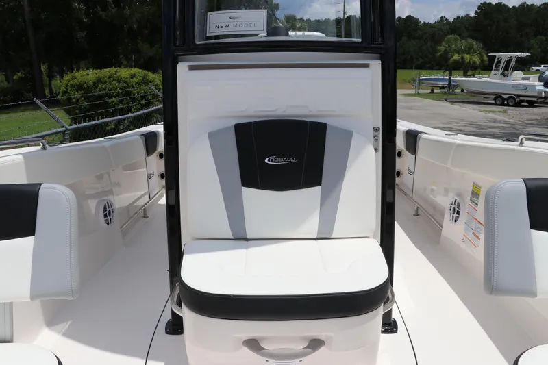 Slide: The Image of 2024 Robalo R230 Center Console boat interior with seating and console view. - 23
